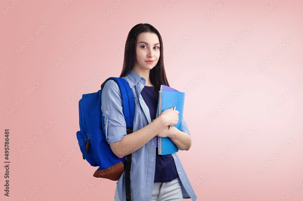 Smiling happy fun student girl with backpack hold pile of books. Education concept Smiling happy fun student girl with backpack hold pile of books. Education concept