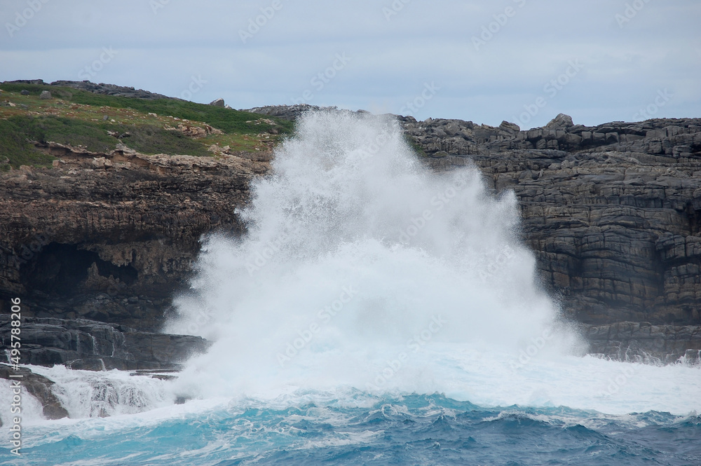 Wave crashing on cliff