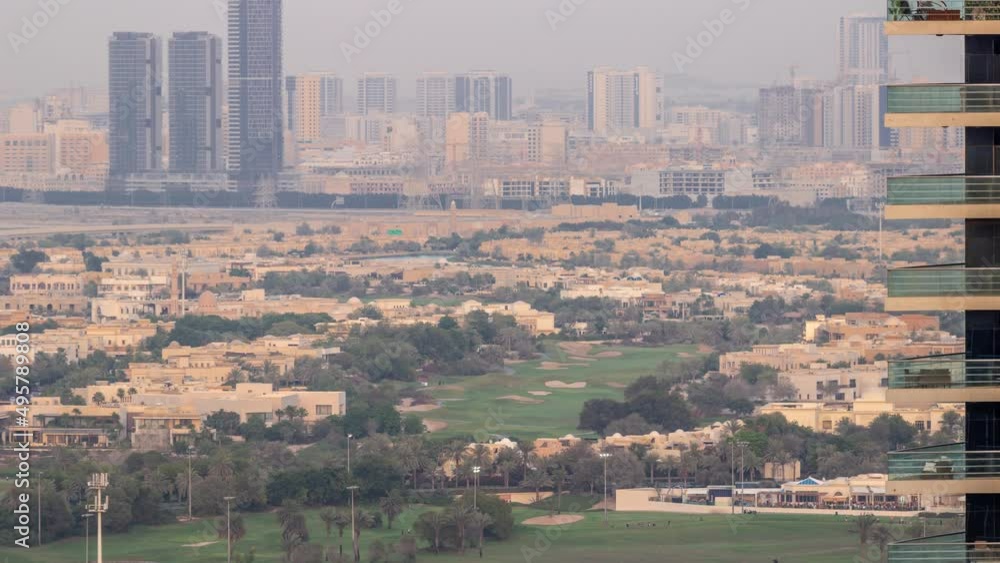 Aerial view of housing development promenade with JLT district skyscrapers and artificial lake with a park timelapse. Aerial view of housing development promenade with JLT district skyscrapers and artificial lake with a park timelapse.
