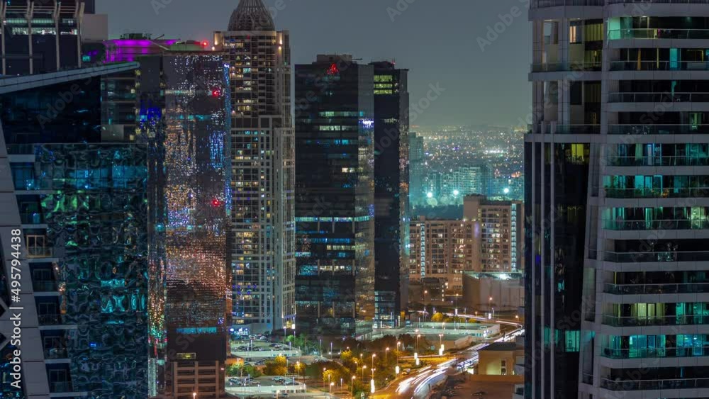Tall residential buildings at JLT aerial night timelapse, part of the Dubai multi commodities centre mixed-use district. Tall residential buildings at JLT aerial night timelapse, part of the Dubai multi commodities centre mixed-use district.
