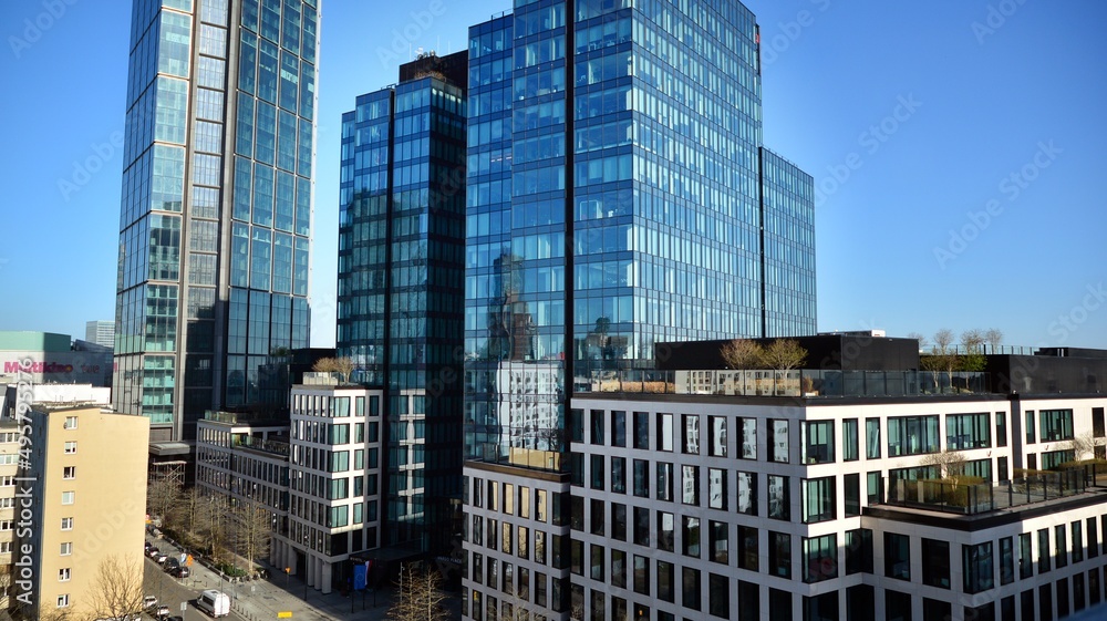 Glass building with transparent facade of the building and blue sky. Structural glass wall reflecting blue sky. Abstract modern architecture fragment. Contemporary architectural background.