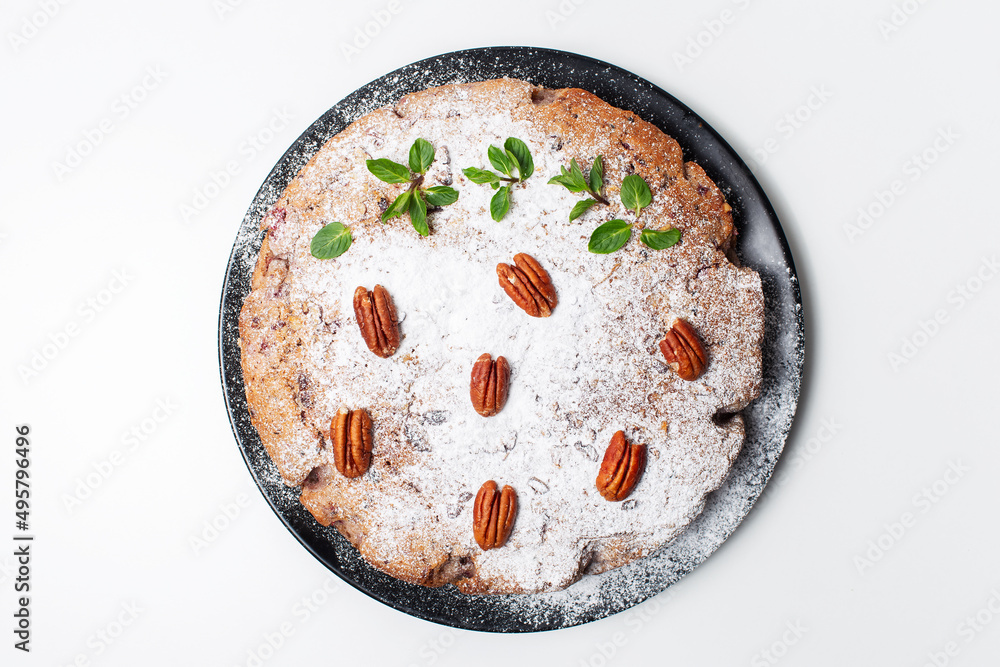 Vegan food. Top view of homemade pie in black plate on white table. Vegan food. Top view of homemade pie in black plate on white table.