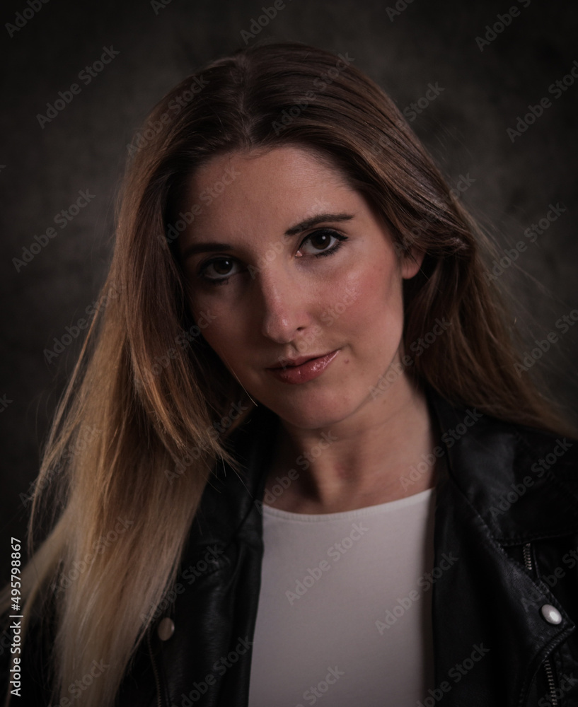 Young beautiful woman looks at the camera - photo shooting - studio photography