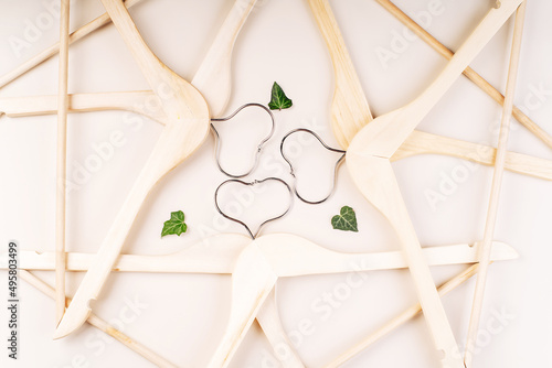 Hangers with plants on white background with copy space.Conscious and environmentally friendly consupmtion in shopping.Zero waste.Shopping,sale,promo, concept.Top view flat lay copy space.