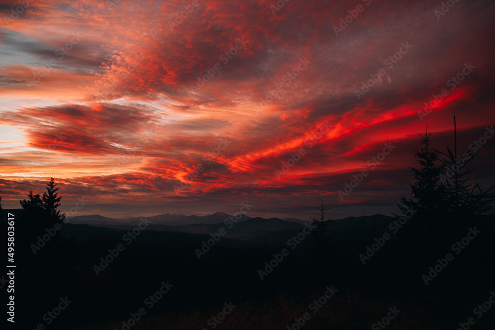 Magical sunset in the mountains. The sky is covered with clouds Magical sunset in the mountains. The sky is covered with clouds