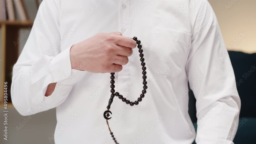 Man praying with rosary beads close-up, islamic religion. Religious holiday Ramadan, holy month. Muslim worship, male person making traditional prayer to God. Man praying with rosary beads close-up, islamic religion. Religious holiday Ramadan, holy month. Muslim worship, male person making traditional prayer to God.