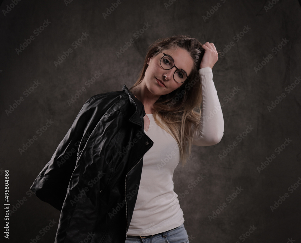 Close-up of a young attractive woman against dark grey background - studio photography Close-up of a young attractive woman against dark grey background - studio photography