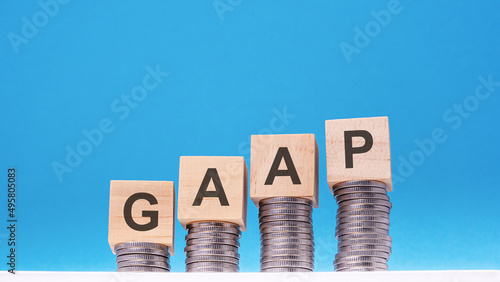 gaap - text on wood cube block stack with coins photo