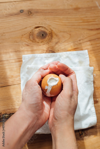 Female hands hollowed and stuffed egg to make easter eggs with cement