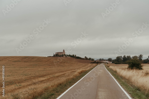 Road cutting through plains in Atapuerca, Burgos on a cloudy sky background photo