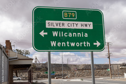 Closeup of a big metal road sign under the cloudy sky photo