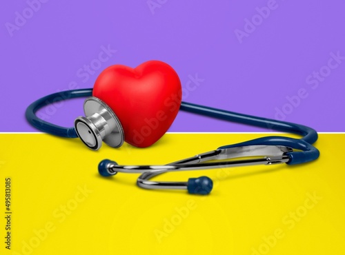 The medical stethoscope lies on the national flag of Ukraine yellow-blue