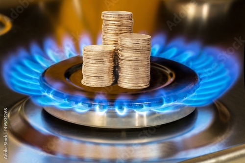 Concept is to increase the cost of supply , payment for gas. Coins stack up on a burning gas burner.