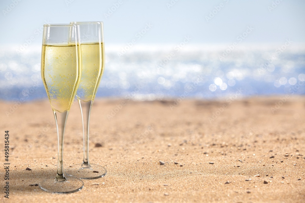 Two Champagne glass on ocean at summer sunset. Tropical travel vacation trip concept