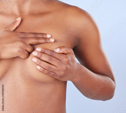 How do you perform a breast self-examination. Studio shot of an unrecognisable woman examining her breast. photo