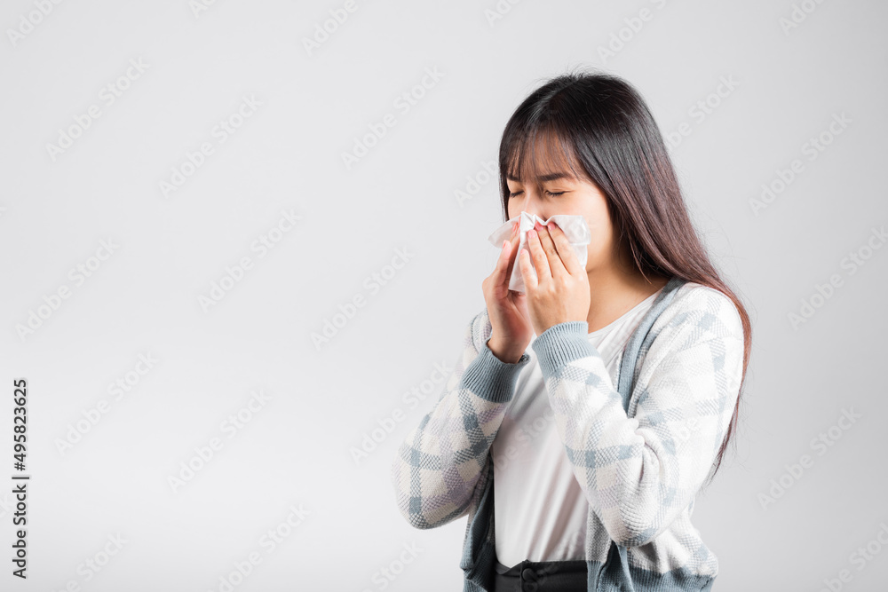 Unhappy woman bad mood her cry wipe mucus with tissue, beautiful young female stress feel sneezing sinus use towel to wipe snot from nose, studio shot isolated on white background with copy space Unhappy woman bad mood her cry wipe mucus with tissue, beautiful young female stress feel sneezing sinus use towel to wipe snot from nose, studio shot isolated on white background with copy space
