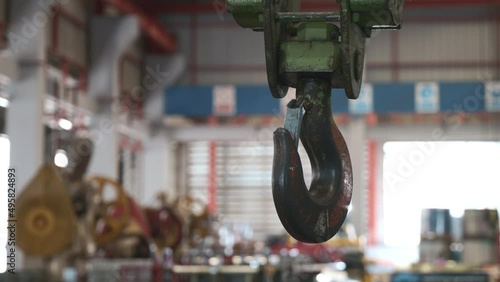 Closeup of swivel chain hook crane of electric hoist in factory workshop, pullersSwivel chain hook equipment for pullers, industry lifting machine photo