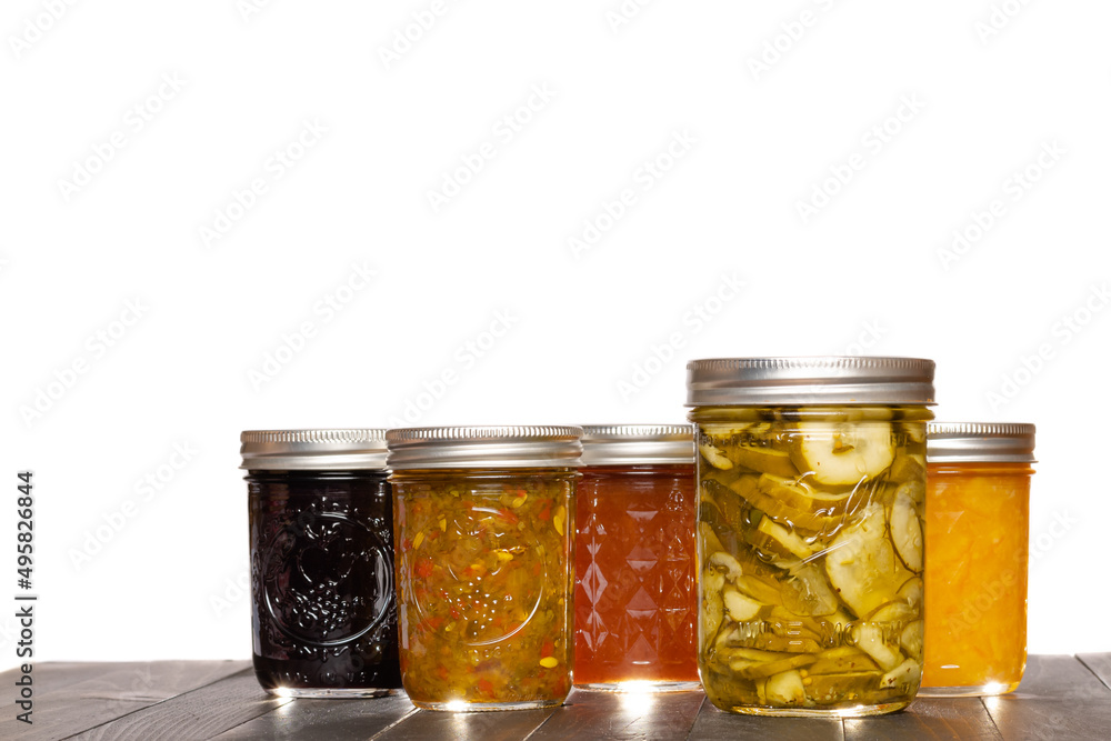 Preserved Pickle Slices Relish Fruit Jams and Jelly in Glass Canning Jars White Background Preserved Pickle Slices Relish Fruit Jams and Jelly in Glass Canning Jars White Background