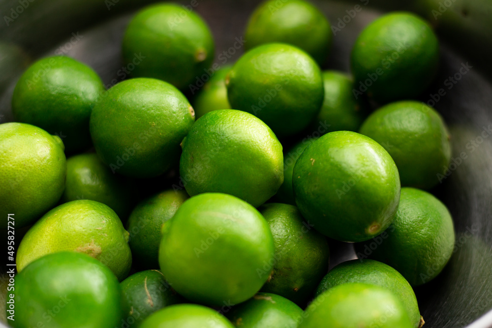 Varios limones verdes en un tazon. Concepto de frutos, naturaleza. Varios limones verdes en un tazon. Concepto de frutos, naturaleza.
