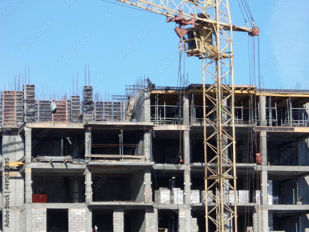 Building under construction. Kazakhstan (Ust-Kamenogorsk). Residential building. Construction crane. Cranes and building. New residential area. Construction site. Concrete frame. Monolith