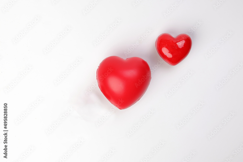 Fototapeta premium small large three dimension 3d red hart shape symbol on top of white background copy text space top view