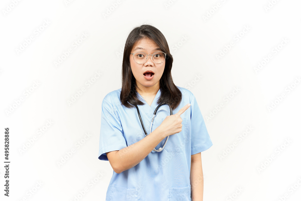 Showing Product and Pointing Side Of Asian Young Doctor Isolated On White Background Showing Product and Pointing Side Of Asian Young Doctor Isolated On White Background