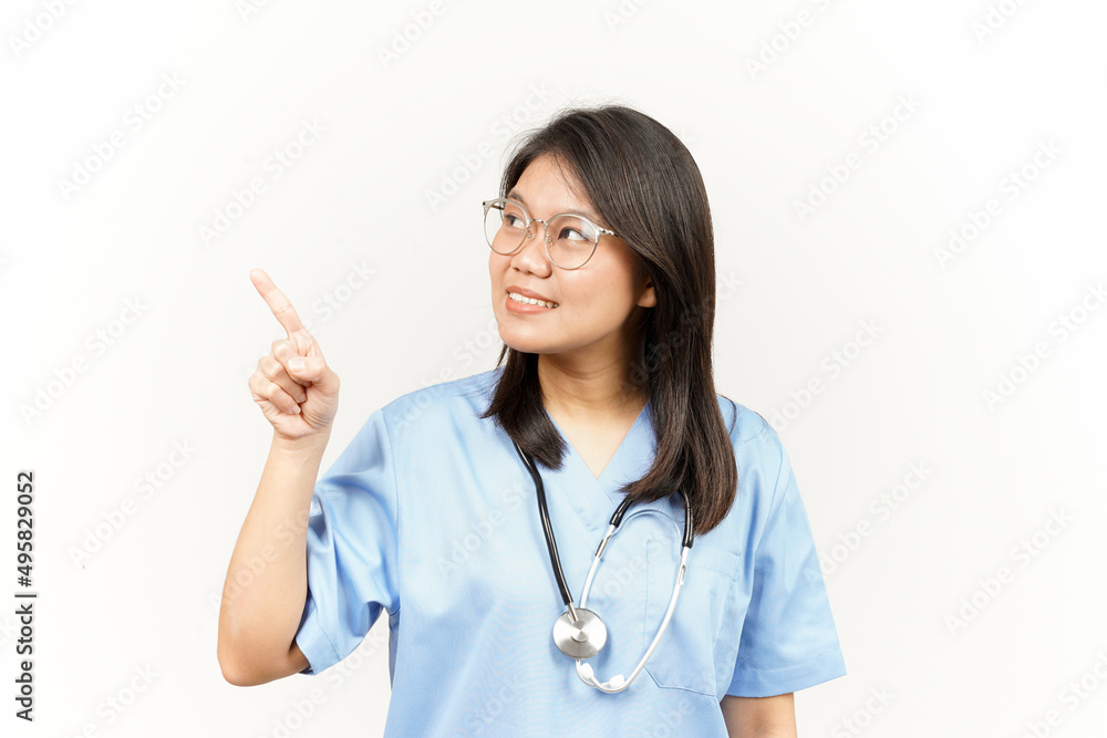 Showing Product and Pointing Side Of Asian Young Doctor Isolated On White Background Showing Product and Pointing Side Of Asian Young Doctor Isolated On White Background