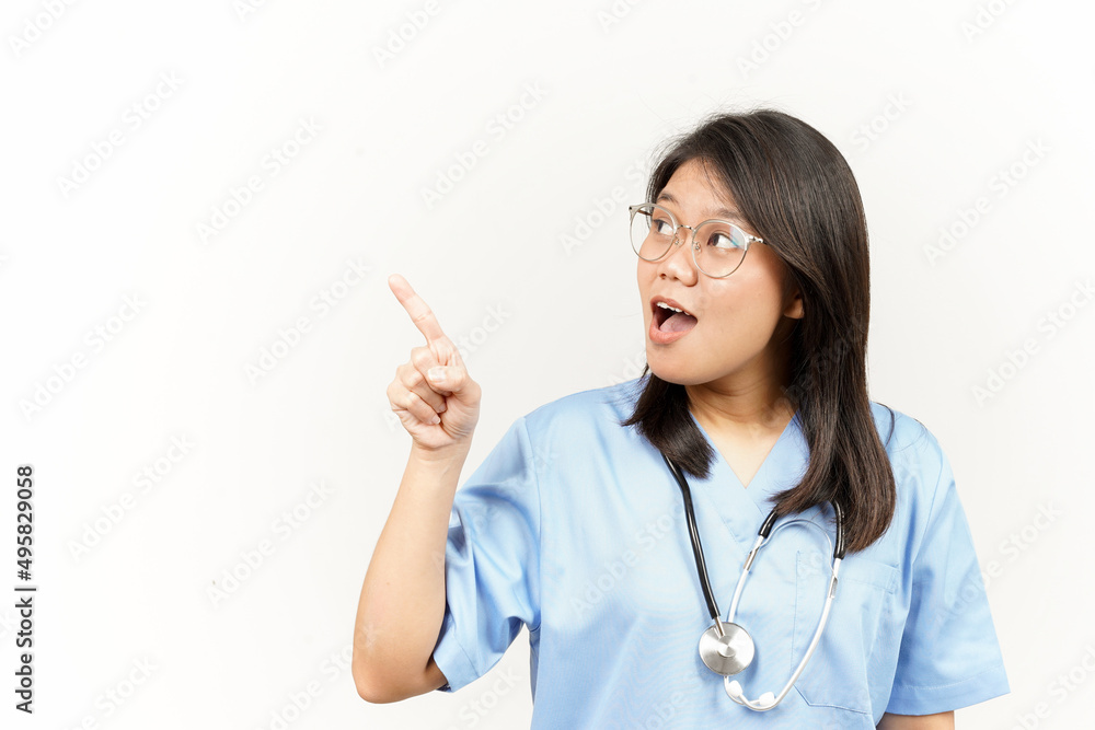 Showing Product and Pointing Side Of Asian Young Doctor Isolated On White Background Showing Product and Pointing Side Of Asian Young Doctor Isolated On White Background