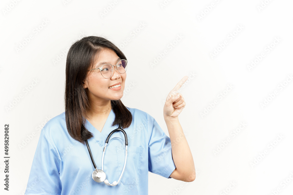 Showing Product and Pointing Side Of Asian Young Doctor Isolated On White Background Showing Product and Pointing Side Of Asian Young Doctor Isolated On White Background