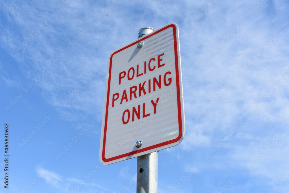 Police Parking Only road sign on pole against blue sky Police Parking Only road sign on pole against blue sky