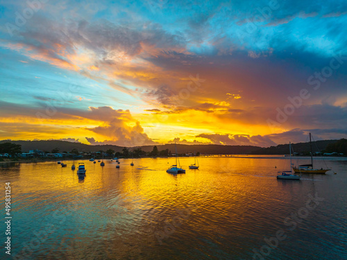 Aerial sunrise waterscape with boats  colour and clouds