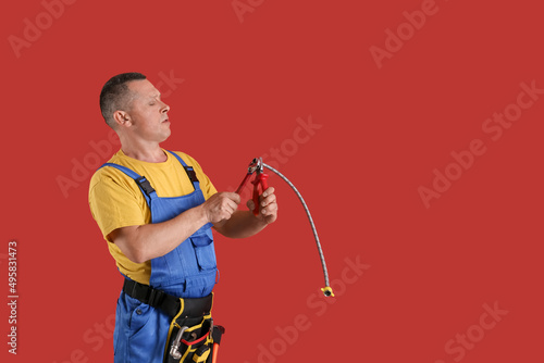 Handsome plumber on color b...