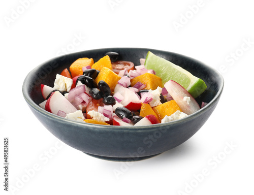 Bowl of tasty Mexican vegetable salad with radish and black beans on white background