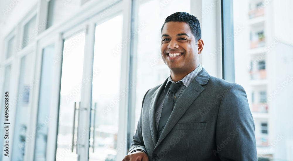 Nothing makes a statement like a stylish suit. Portrait of a confident young businessman working in a modern office. Nothing makes a statement like a stylish suit. Portrait of a confident young businessman working in a modern office.