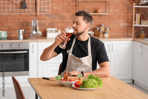 Handsome man drinking beer ...