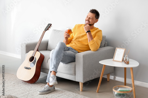 Handsome man drinking beer ...