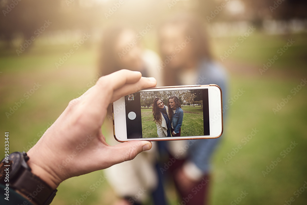 Making some memories with the bestie. Shot of two cheerful young friends taking a self portrait together outside in a park.