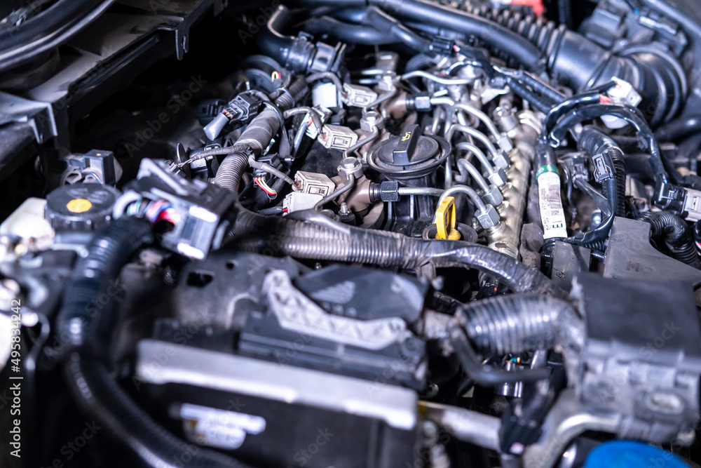 Fototapeta premium Engine car service mechanic maintenance inspection service maintenance car Check engine oil level car in garage showroom dealership blurred background.