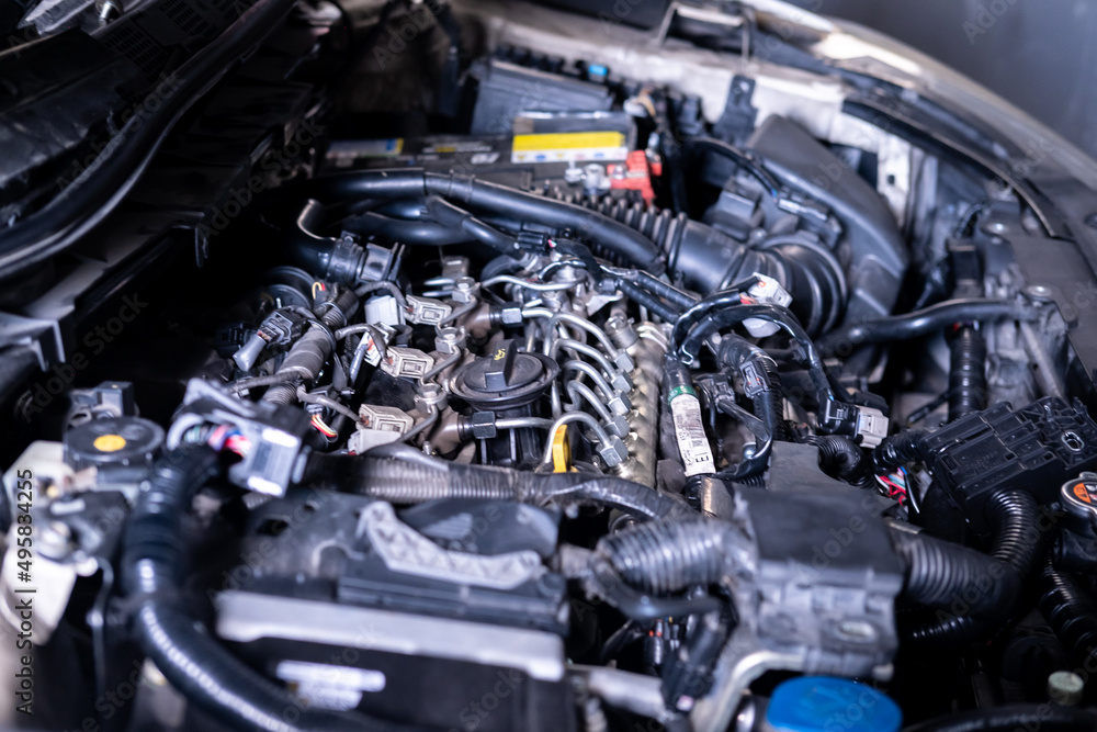 Engine car service mechanic maintenance inspection service maintenance car Check engine oil level car in garage showroom dealership blurred background. Engine car service mechanic maintenance inspection service maintenance car Check engine oil level car in garage showroom dealership blurred background.