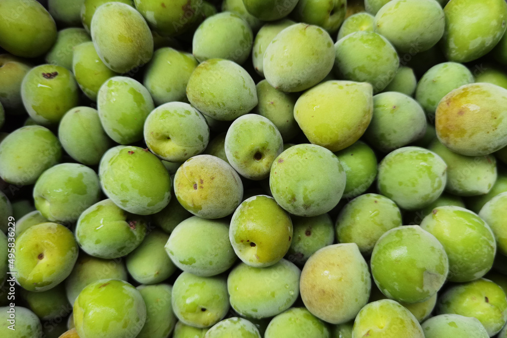 close up of green plum fruits for background close up of green plum fruits for background