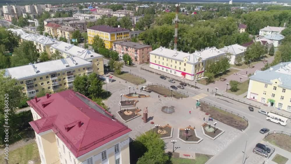 Aerial view of Square with flower beds and a small fountain and monument to the writer Bazhov P.P. and beautiful alley in a provincial city with low buildings. Alley with sculptures, lanterns, benches Aerial view of Square with flower beds and a small fountain and monument to the writer Bazhov P.P. and beautiful alley in a provincial city with low buildings. Alley with sculptures, lanterns, benches