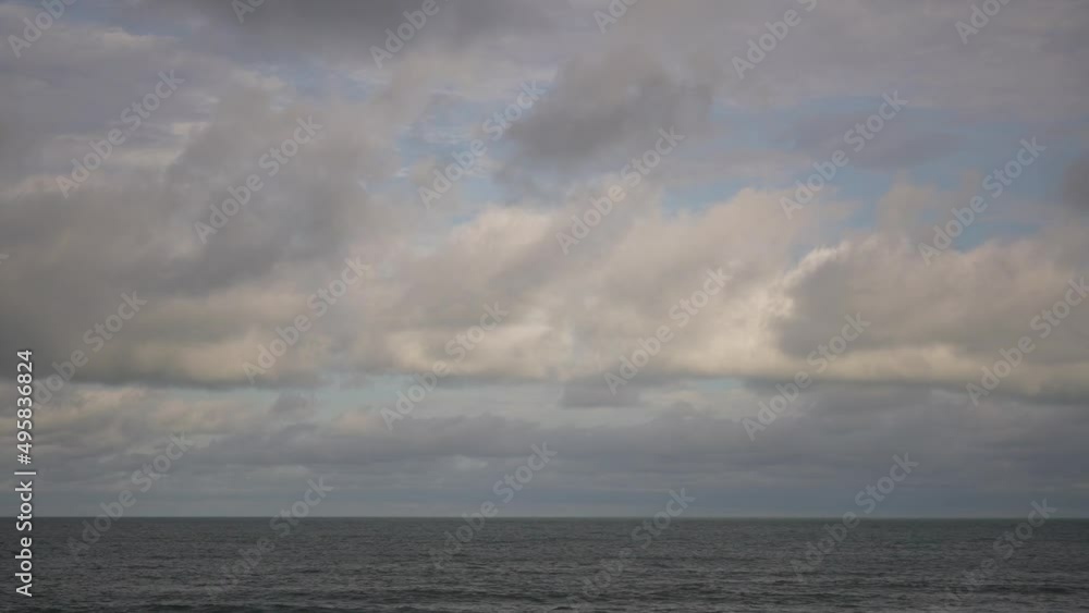 Clouds floating on sky over sea water in the evening, time lapse Clouds floating on sky over sea water in the evening, time lapse