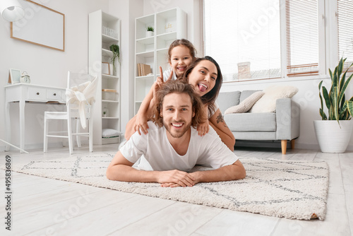 Happy young family lying on...