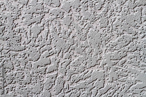 Abstract background texture of the wall with a relief coating.