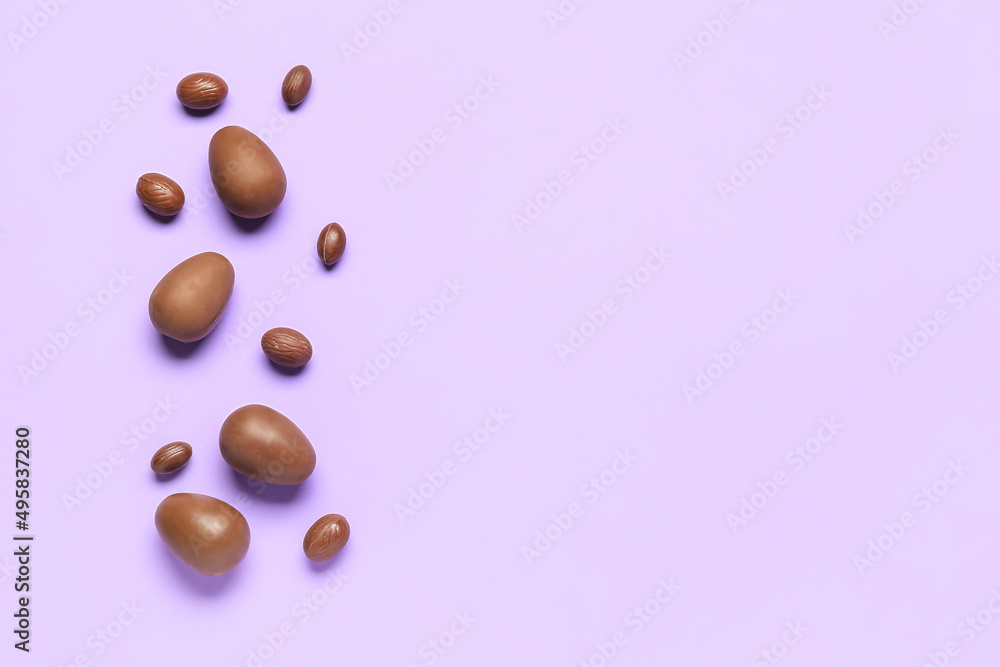 Delicious chocolate eggs on purple background Delicious chocolate eggs on purple background