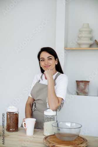 Young brunette woman cooking in kitchen