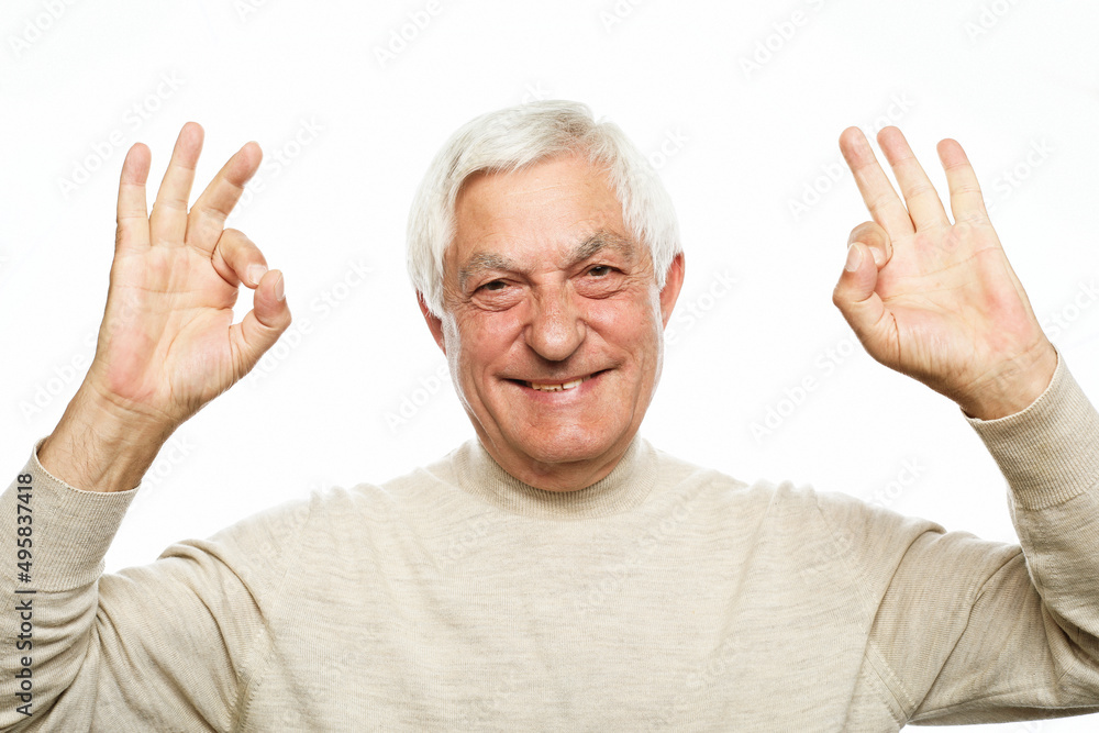 Emotion, lifestyle and old people concept: Portrait of energetic positive old man show okay sign Emotion, lifestyle and old people concept: Portrait of energetic positive old man show okay sign