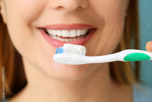 Beautiful mature woman brushing teeth, closeup