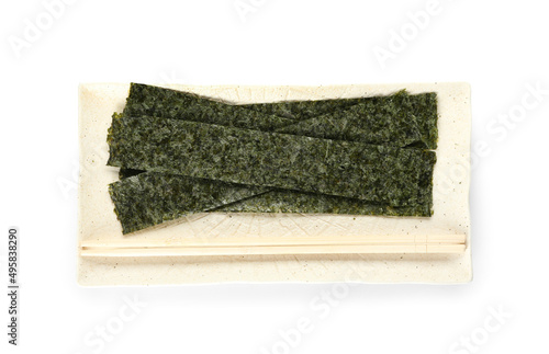 Plate with tasty seaweed sheets and chopsticks on white background