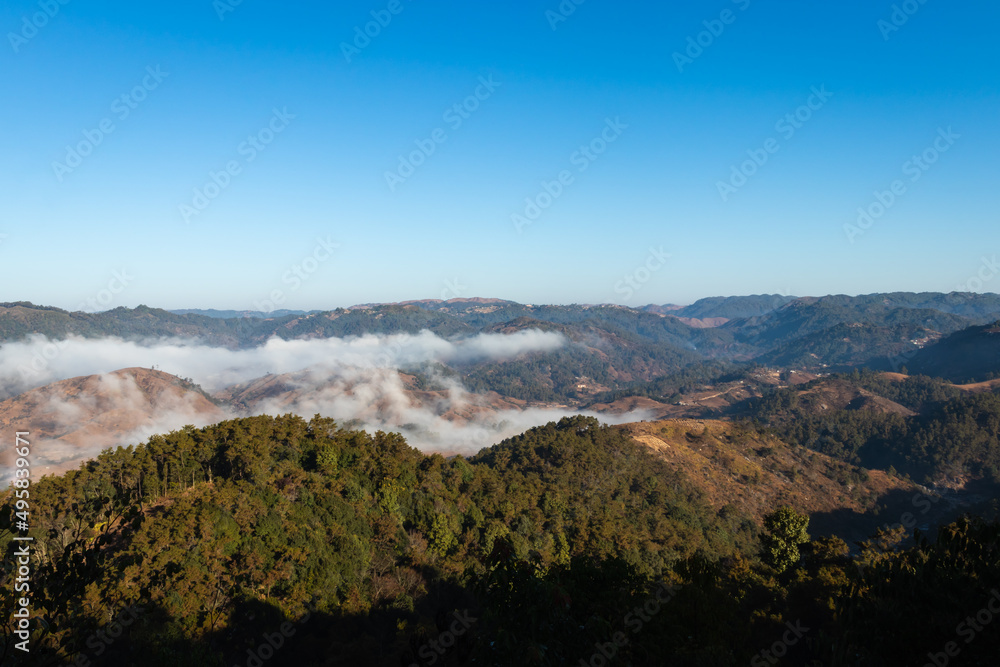 mountain range with low cloud and bright blue sky at morning mountain range with low cloud and bright blue sky at morning
